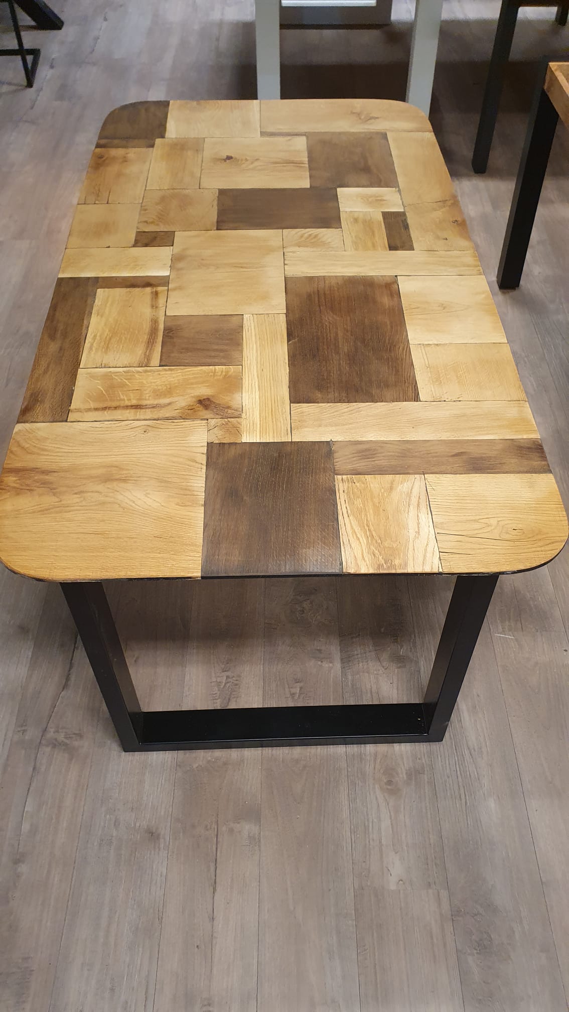 Thermisch oud eiken eettafel van 174x93cm, voorzien van afgeronde hoeken en zwarte u-poten